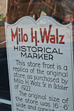 Sign in window of former Milo H. Walz store